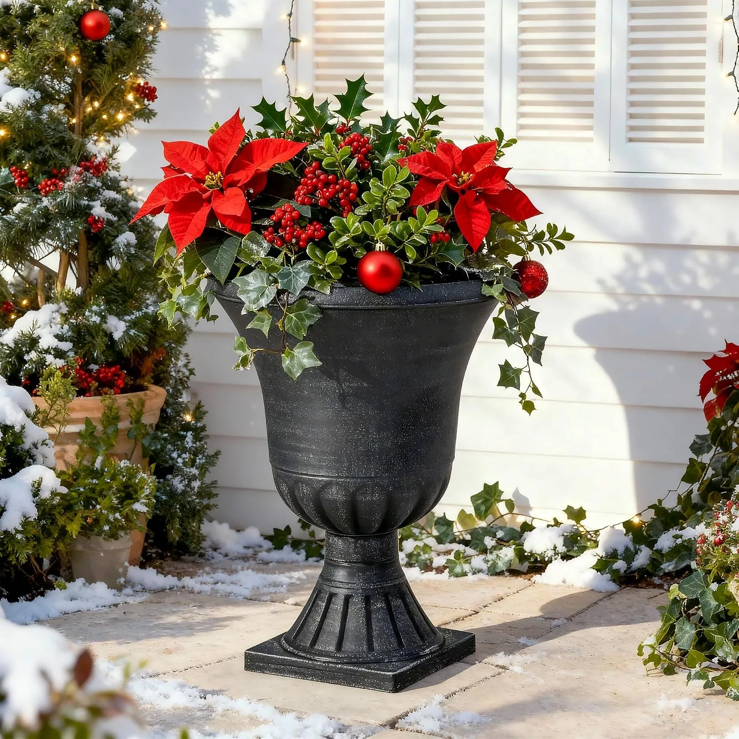 Large black urn planter with poinsettias ivy and winter greenery