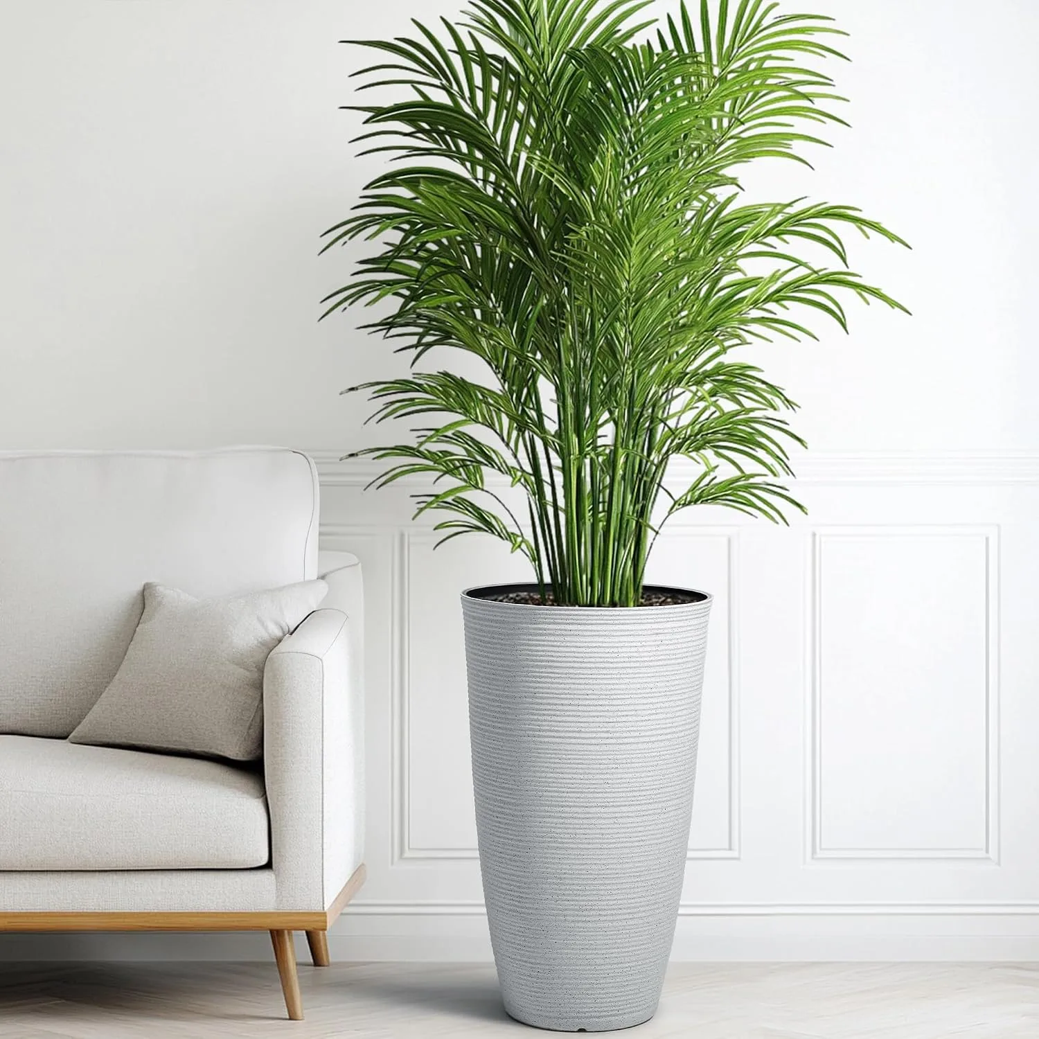 Tall white ribbed planter with large green indoor palm